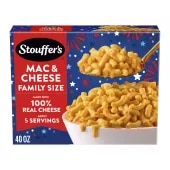 Box of Macaroni & Cheese with a plate and dish of mac & cheese on a table near the product name and "100% REAL CHEESE" label.