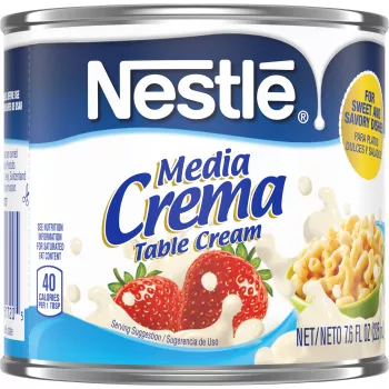 A can of Media Crema table cream with a blue label featuring strawberries, a bowl of macaroni, and cream.